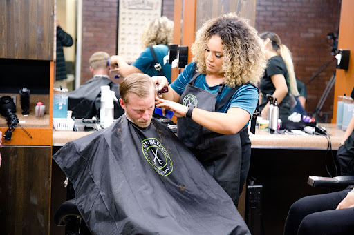 Woman giving man a haircut