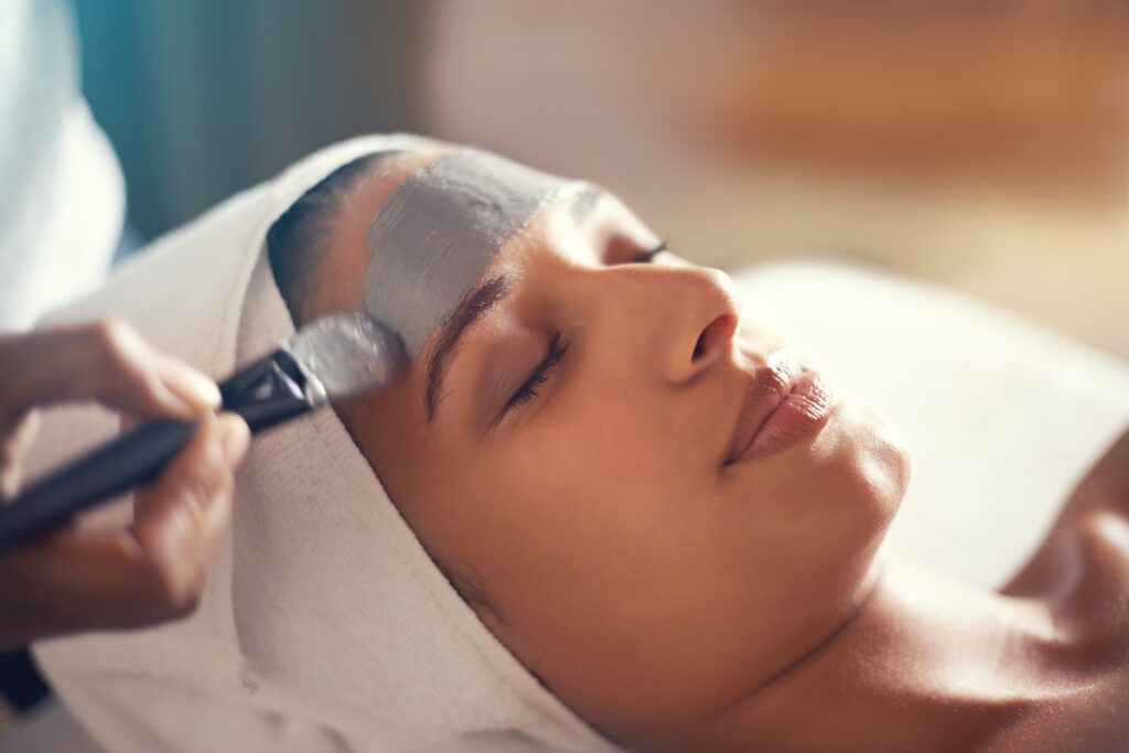 woman getting a facial from trained esthetician