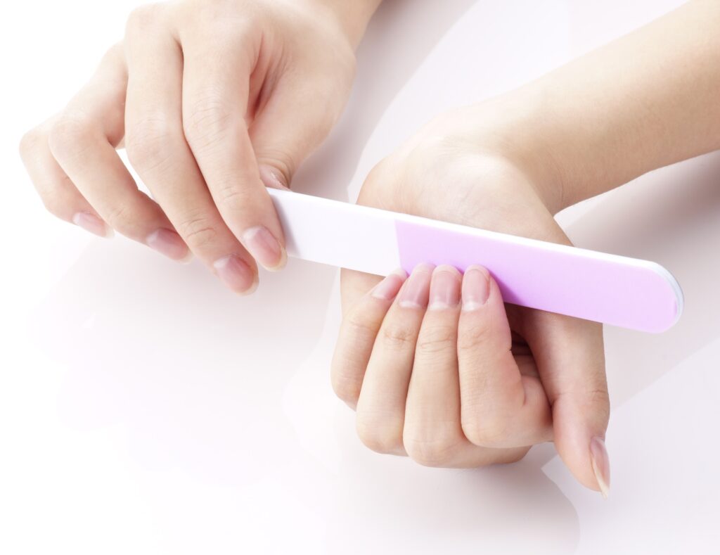 woman conducting nail care