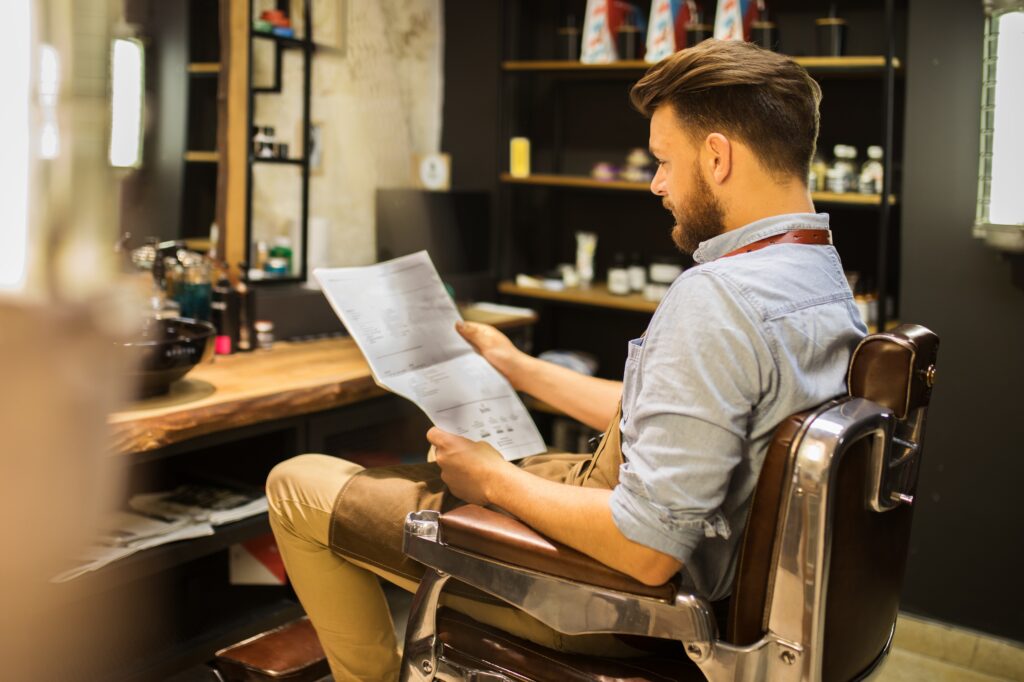 a man reading about barbering trends