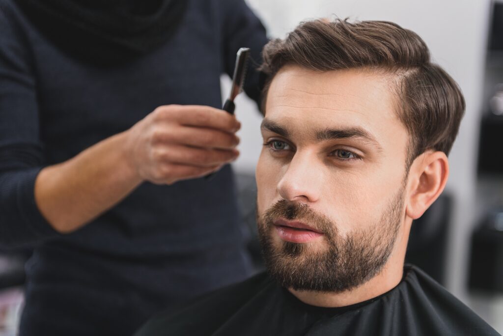 Barbering client getting a new men's hairstyle