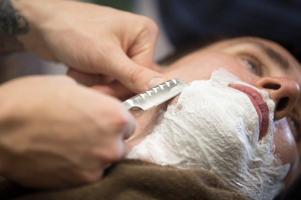 shaving face with a razor