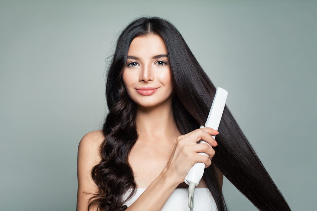 woman styling her curly hair