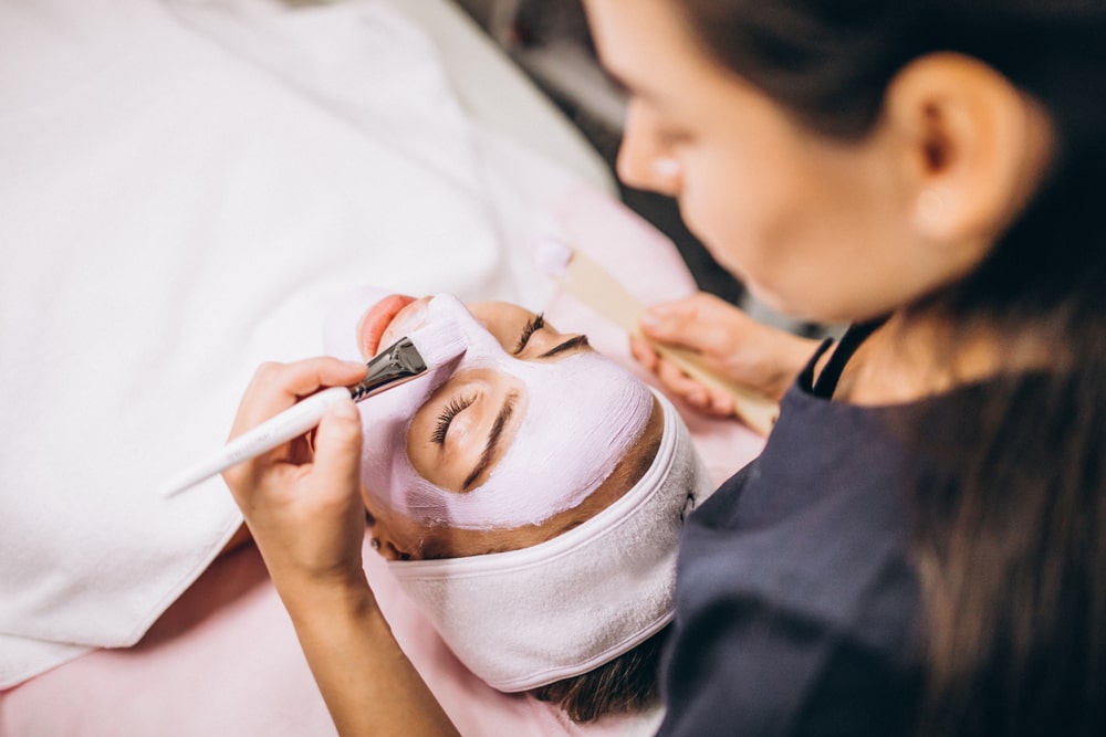 woman giving a facial