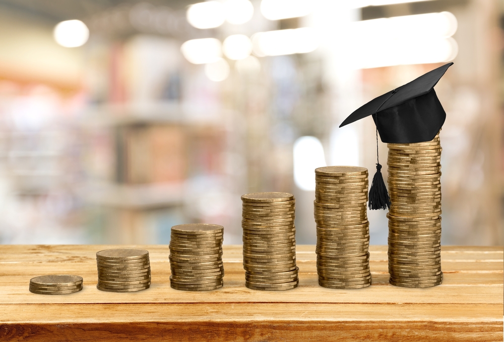 quarters at an incline with a graduation cap on it